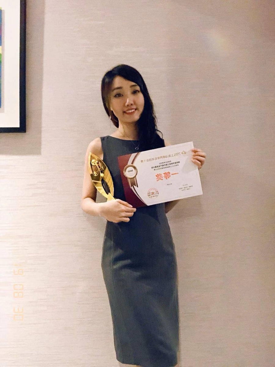 Molly Chen holding a first-prize trophy and certificate