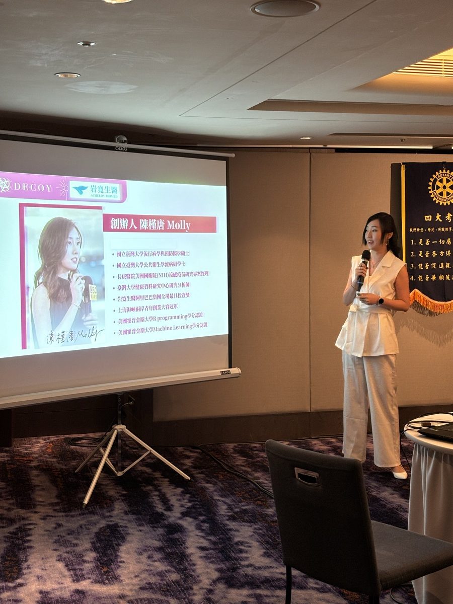 Molly Chen giving a talk at a Rotary Club meeting